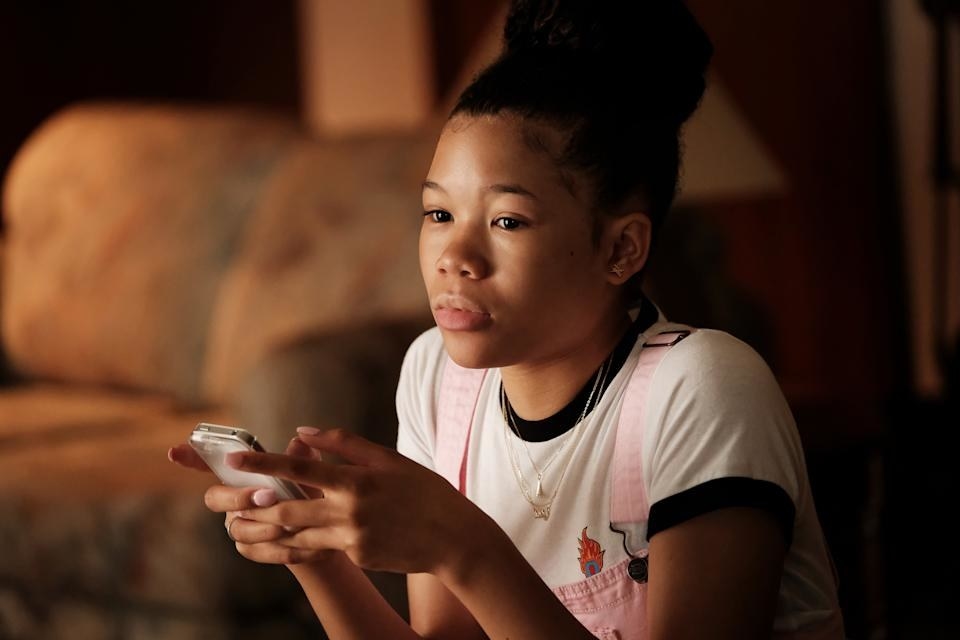 Storm as Gia in &quot;Euphoria&quot; holding a phone in her hand and looking ahead.