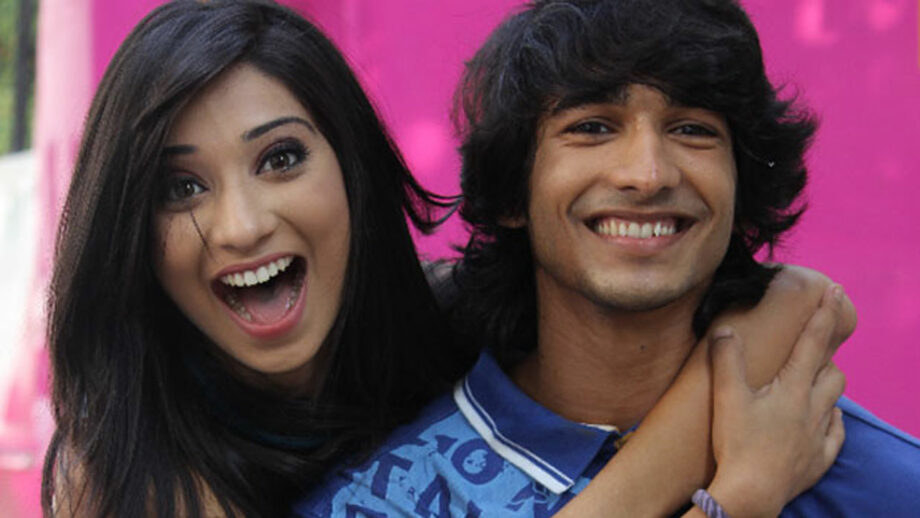 Vrushika Mehta holding Shantanu Maheshwari from behind, with both of them smiling.