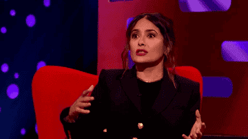 Gif of Salma saying &quot;Shhh&quot; in an exaggerated manner with her fingers to her lips
