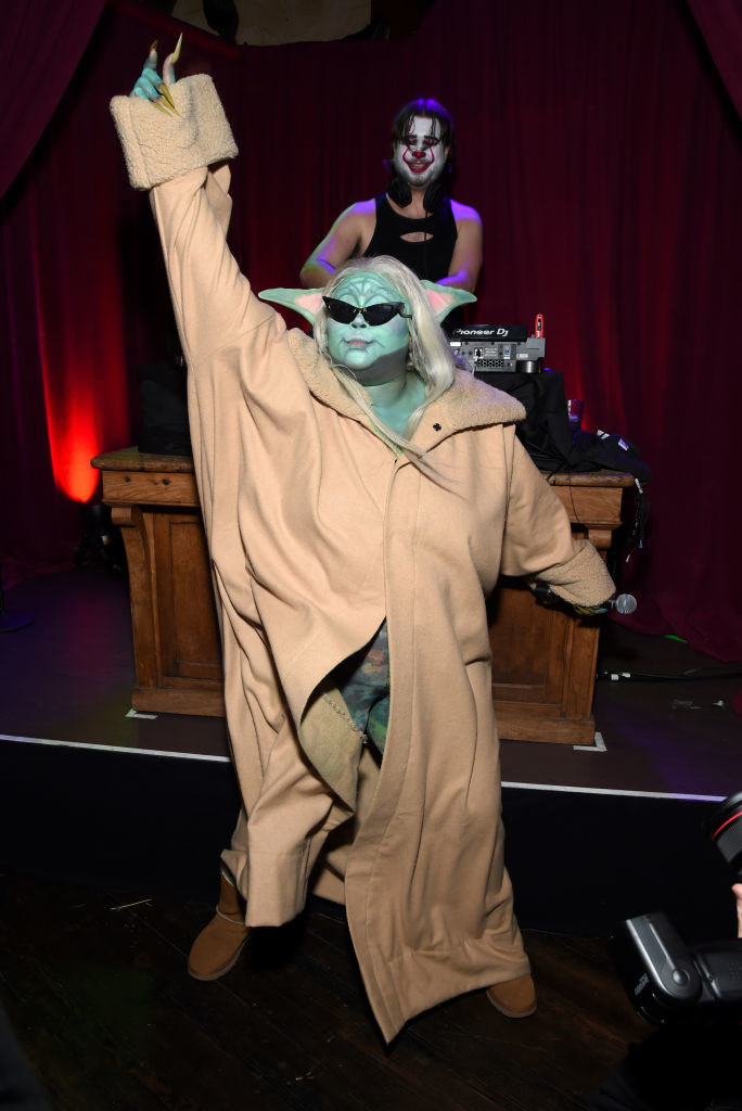 Lizzo in the midst of her performance, enthusiastically raising her hands