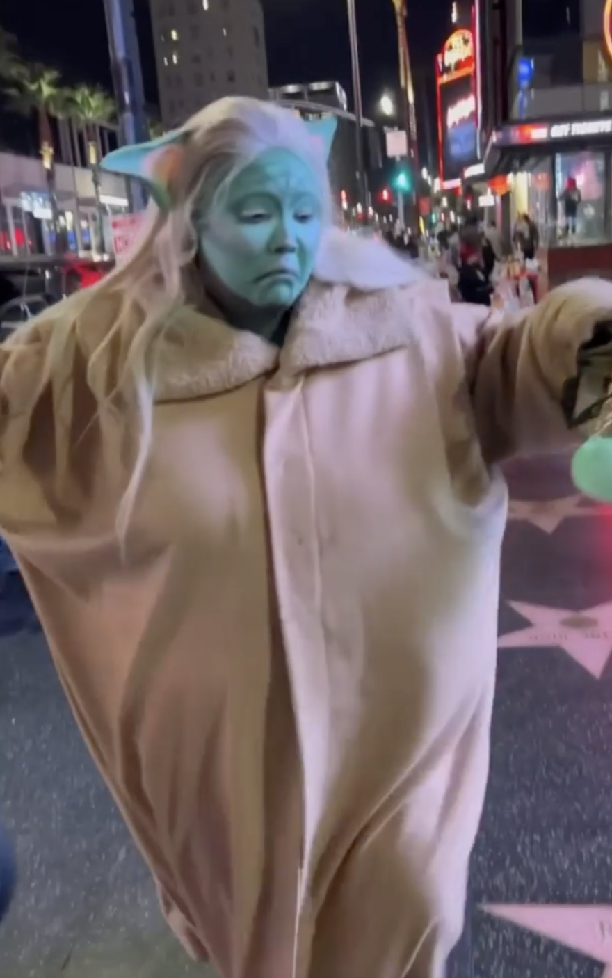 Lizzo walking down the Walk of Fame, her full sack-like Yoda costume visibile