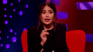 Gif of Salma pointing to her left and shouting &quot;Next door!&quot;