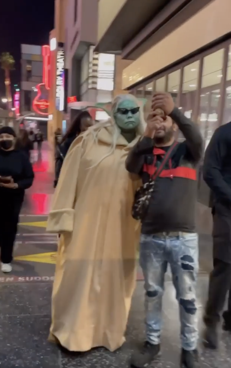 Lizzo posing for a selfie while in costume, presumably unrecognizeable