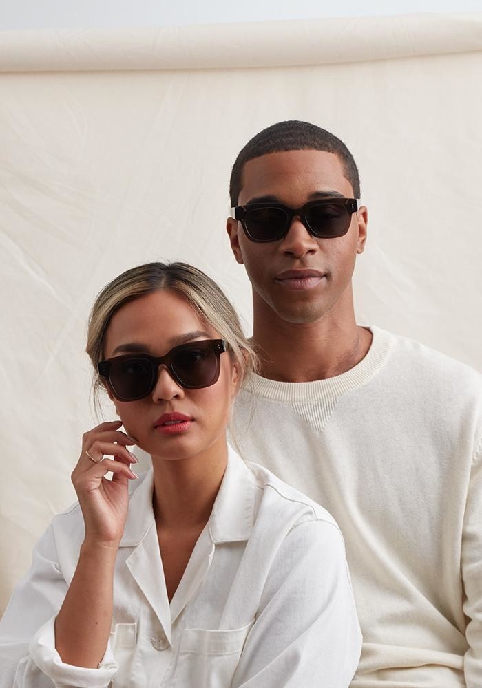 two models wearing the dark gray square frame sunglasses
