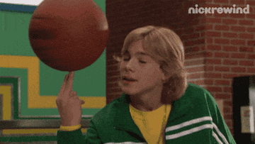 GIF of the original Seth spinning a basketball and brushing his hair back