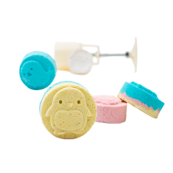 Four colorful bath tablets with animal shapes stamped on them