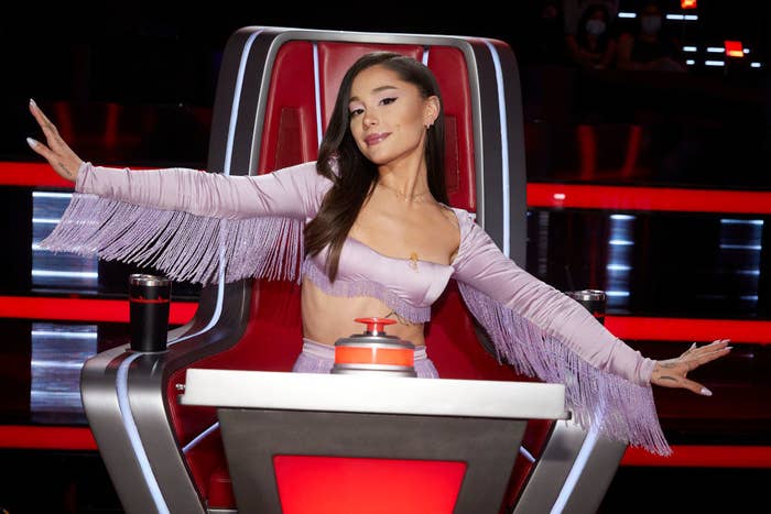 Photo of Ariana as a judge on the voice, she wears a fringed two-piece set