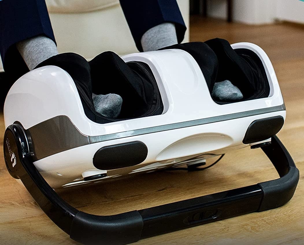 A person with their feet in the foot massager