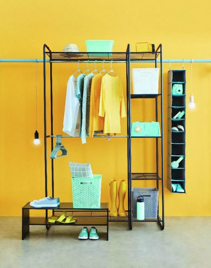 A black garment rack with five shelves, a shoe shelf, and two clothing rods