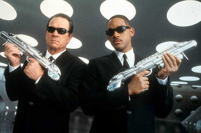 Tommy Lee Jones and Will Smith holding weapons in a publicity portrait for the film &#x27;Men In Black II&#x27;