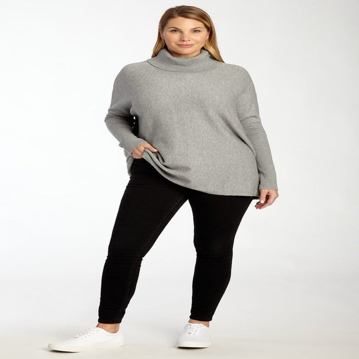 model wearing the gray sweater with black leggings