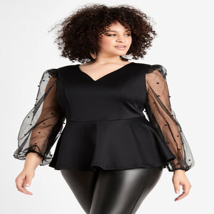 model wearing shirt in black with black shiny leggings