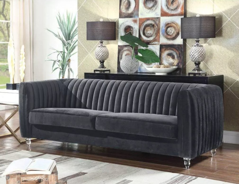 A gray velvet sofa in a living room