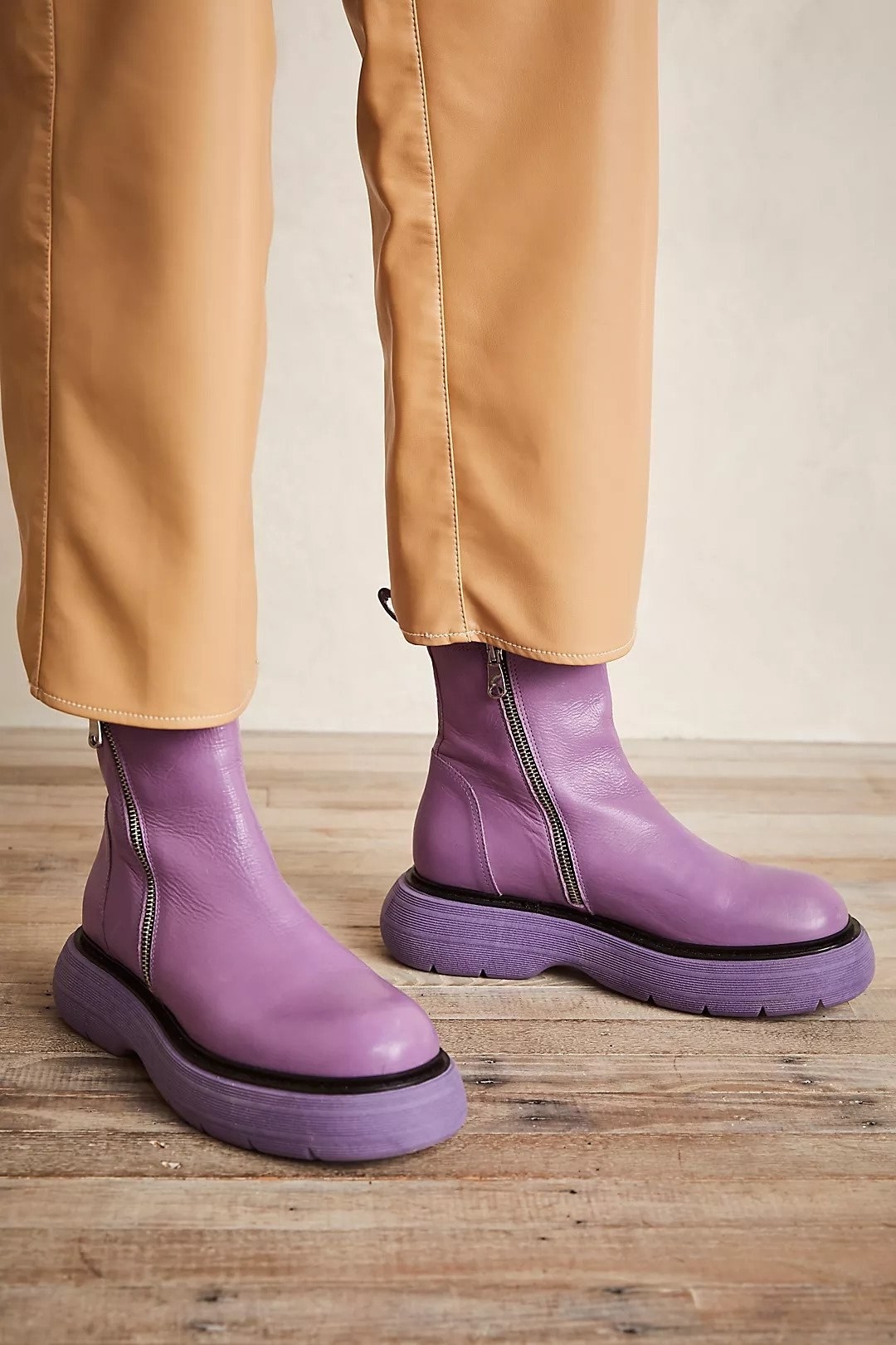 cushy boot with tall, thick soles and over-the-ankle fit in purple color. they zip on.