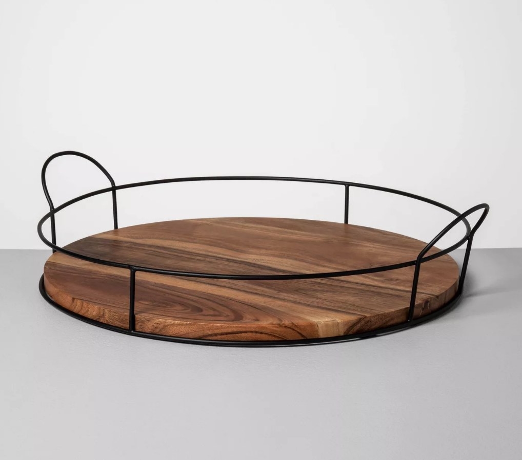 A round, wood and metal decorative tray