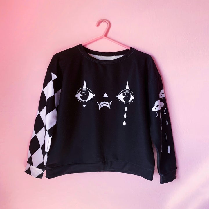 the black and white sweatshirt on a hanger