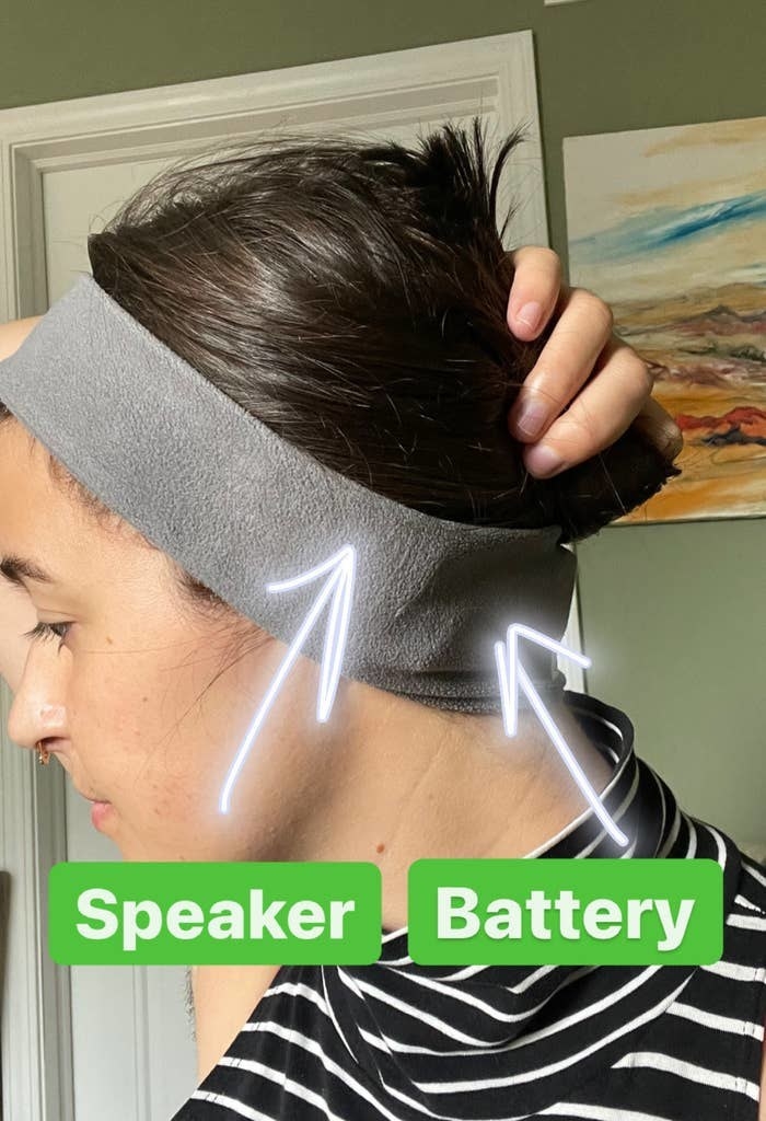 buzzfeed writer rachel wearing the headband with text that says &quot;speaker&quot; and &quot;battery&quot; and arrows pointing to headband