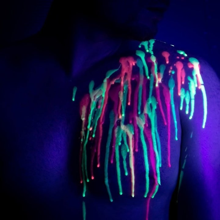 Model covered in fluorescent candles wax
