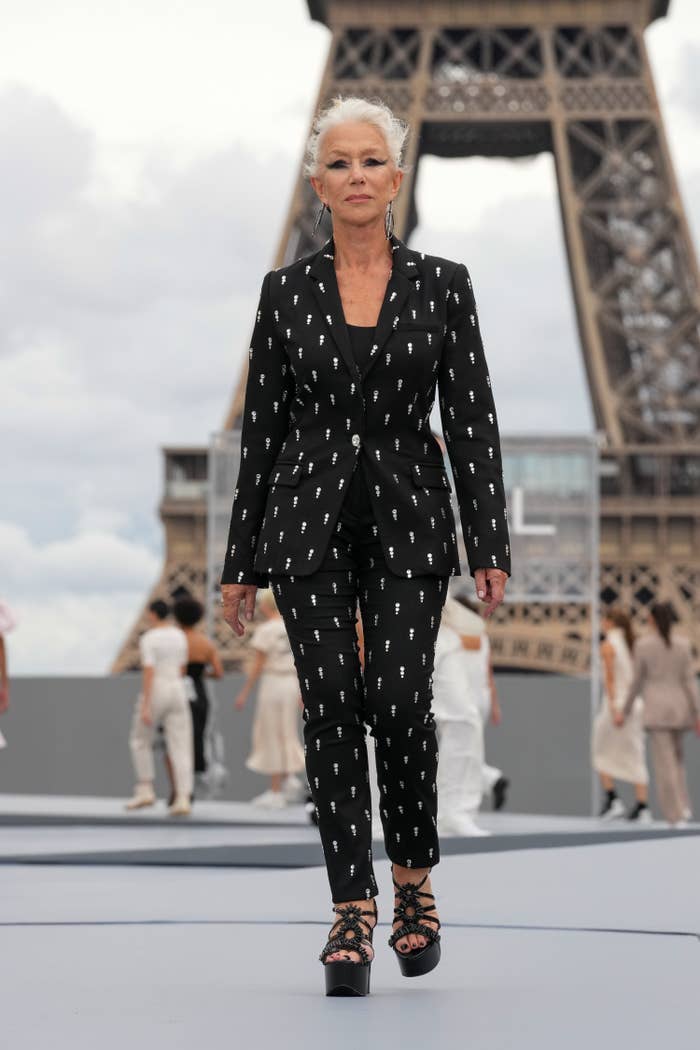 Helen walking in a platform sandals and pantsuit with the Eiffel Tower in the background