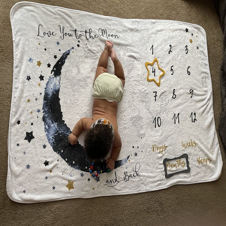 Baby lying on their tummy on the blanket