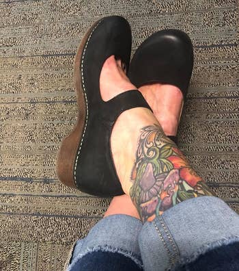 A reviewer wearing the clogs in black