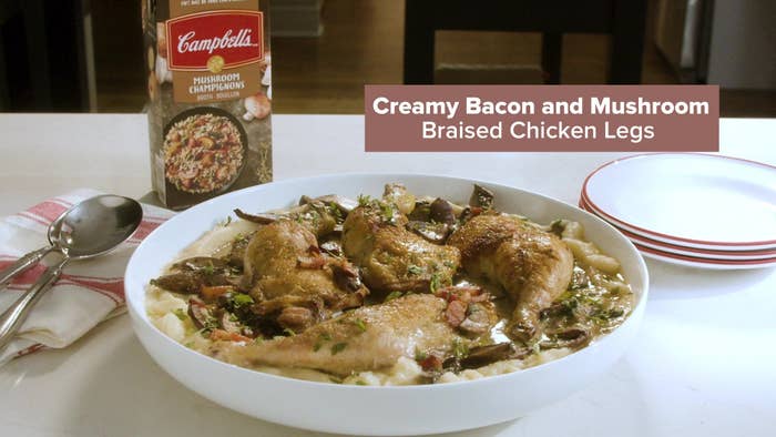 A photo of the Creamy Bacon and Mushroom Braised Chicken Legs in a bowl on a counter.