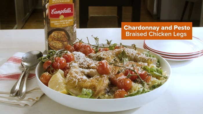 A photo of the Chicken and Pesto Braised Chicken legs in a bowl on a counter.