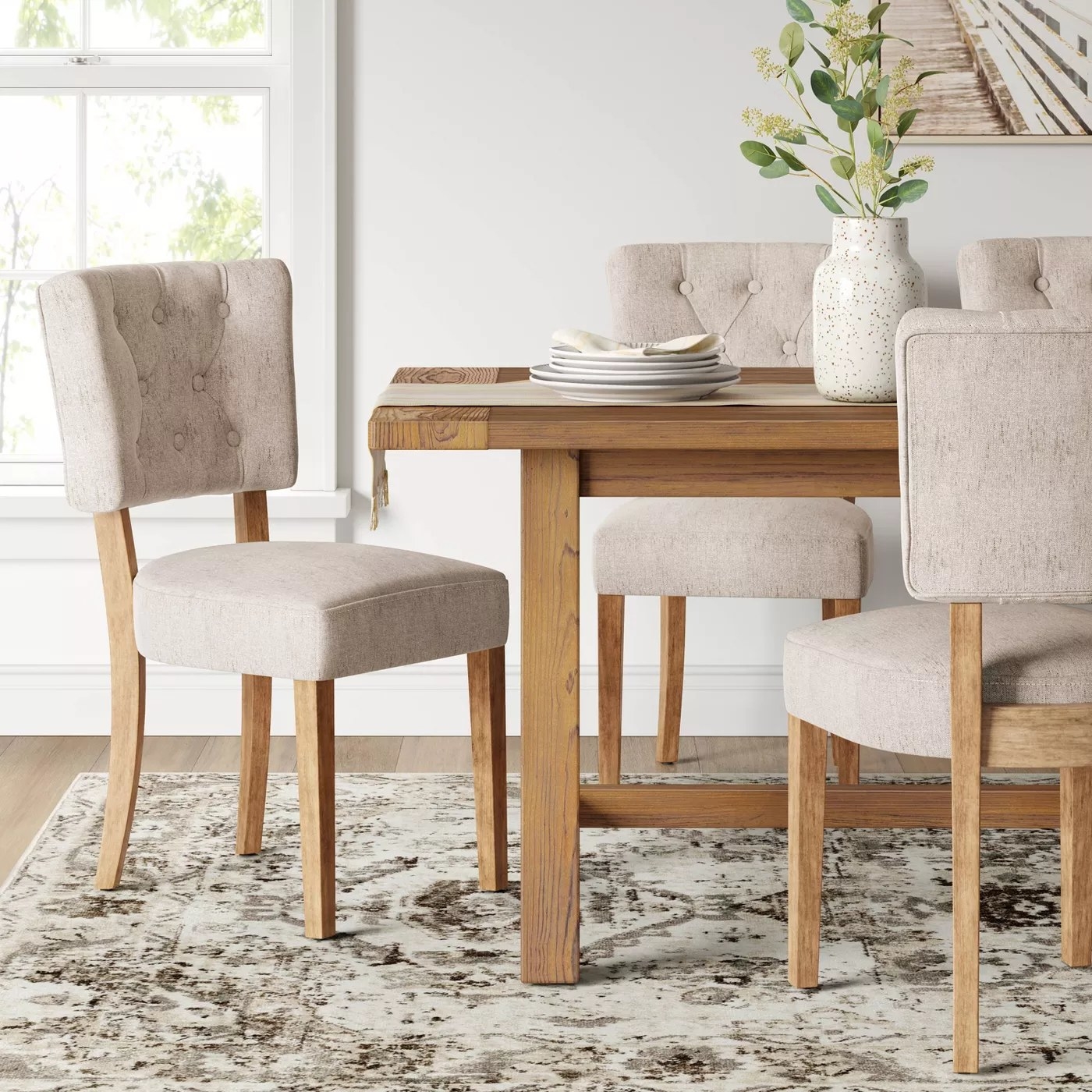 a set of dining chairs around a dining table