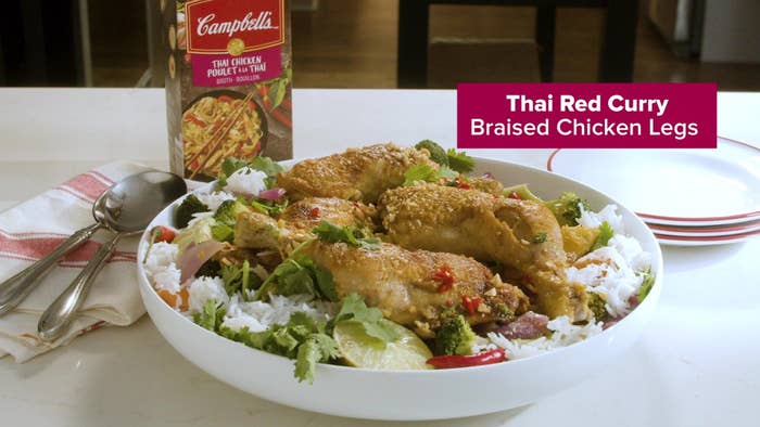 A photo of the Thai Red Curry Braised Chicken legs in a bowl on a counter.