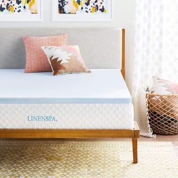 blue gel-infused memory foam mattress topper on wooden bed