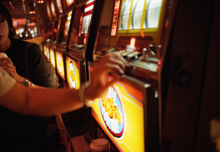 Someone gambling at a slot machine