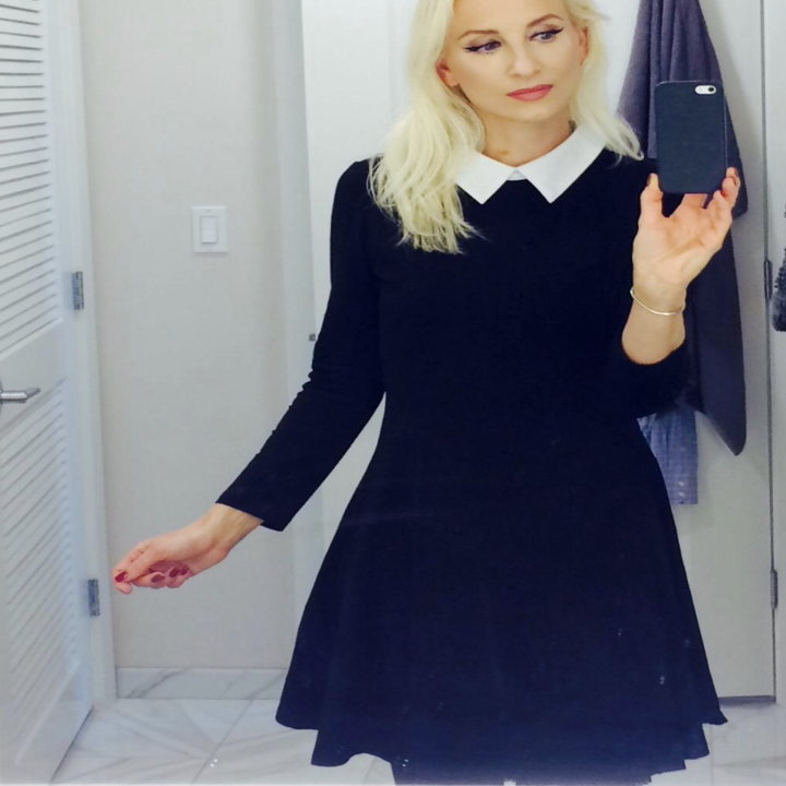 A customer review photo of them wearing the dress while taking a mirror selfie