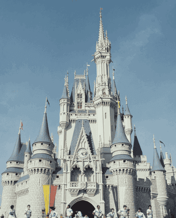 Cinderella&#x27;s castle transitioning from an archival picture to one of its new colors for the 50th anniversary