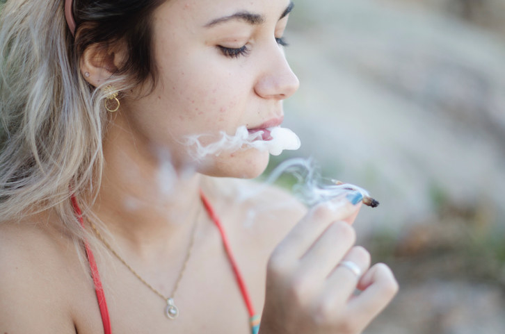 A woman smoking a joint