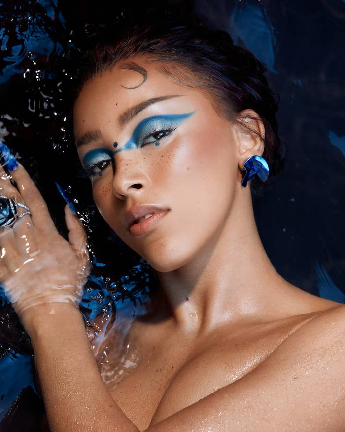 Doja Cat posing with blue makeup