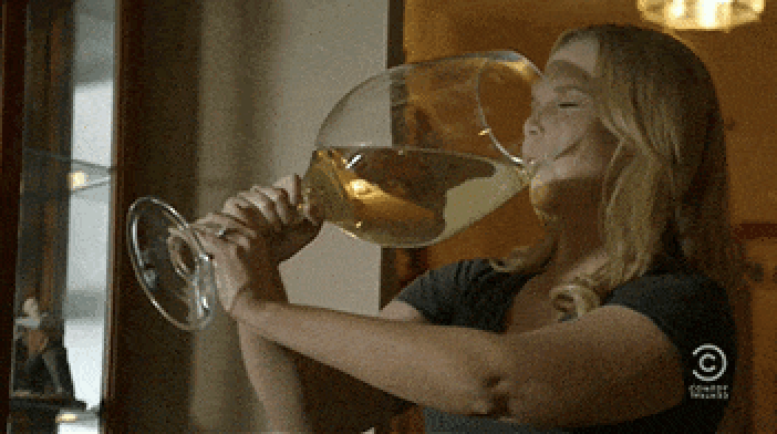 Amy Schumer downing a giant glass of wine