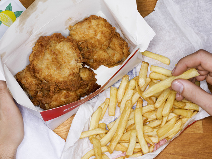 A fast food meal of friend chicken and fries