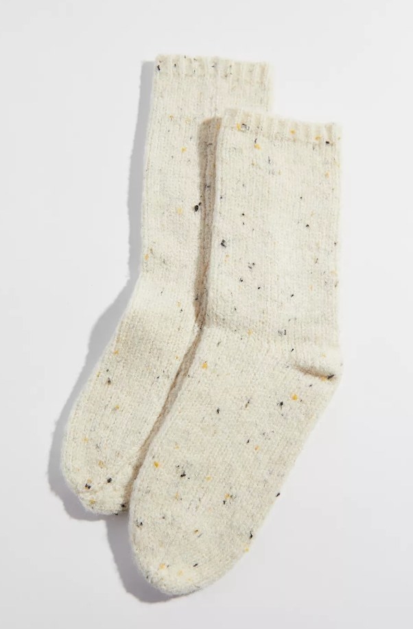White fuzzy socks with black and yellow speckles