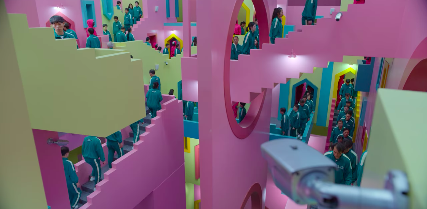 Pink, green and blue mansion that the contestants walk through