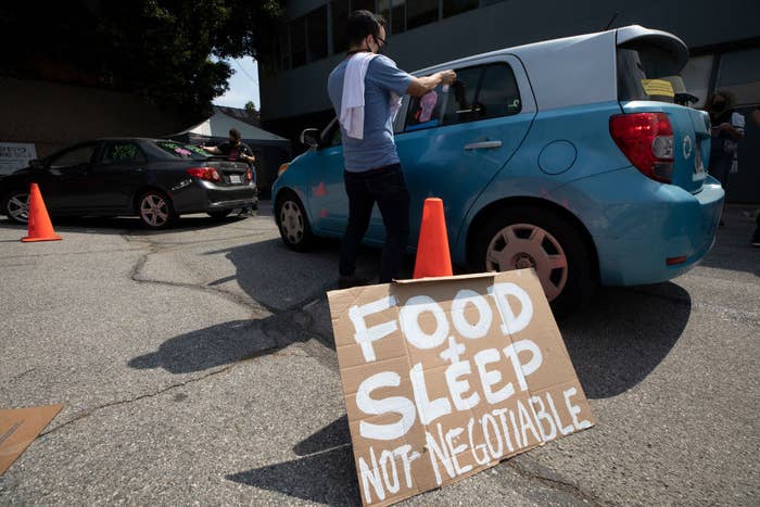 A sign reading &quot;Food and sleep not negotiable&quot; rests on a traffic cone