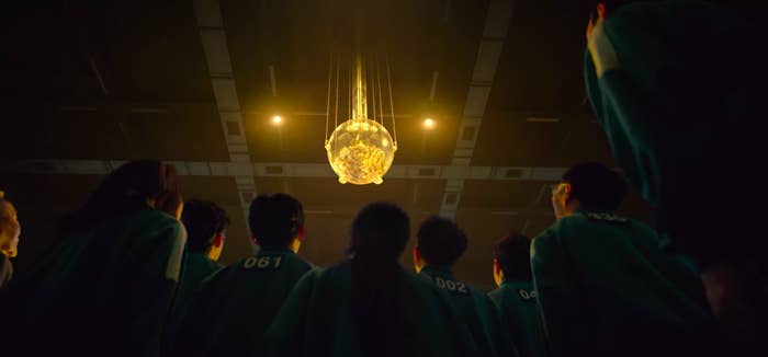 the contestants staring at the glowing ball of cash that they can win