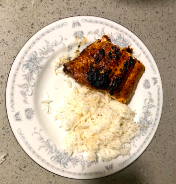 A plate of pan-seared salmon and white rice