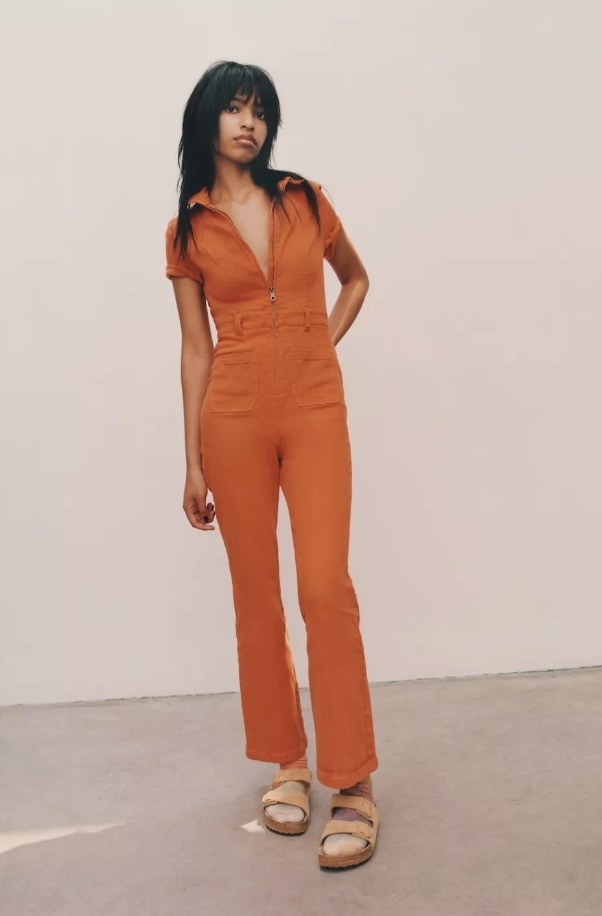 Model wearing short sleeve orange jumper