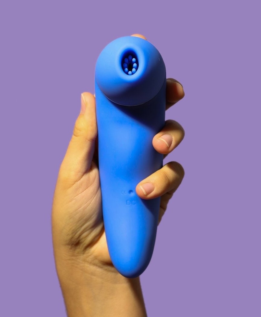 Model holding blue suction vibrator