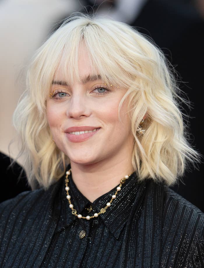 Billie Eilish smiles during a red carpet appearance