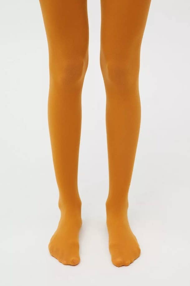 Model wearing orange opaque tights