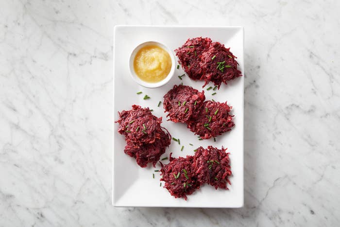 A plate of deep red, beet latkes.