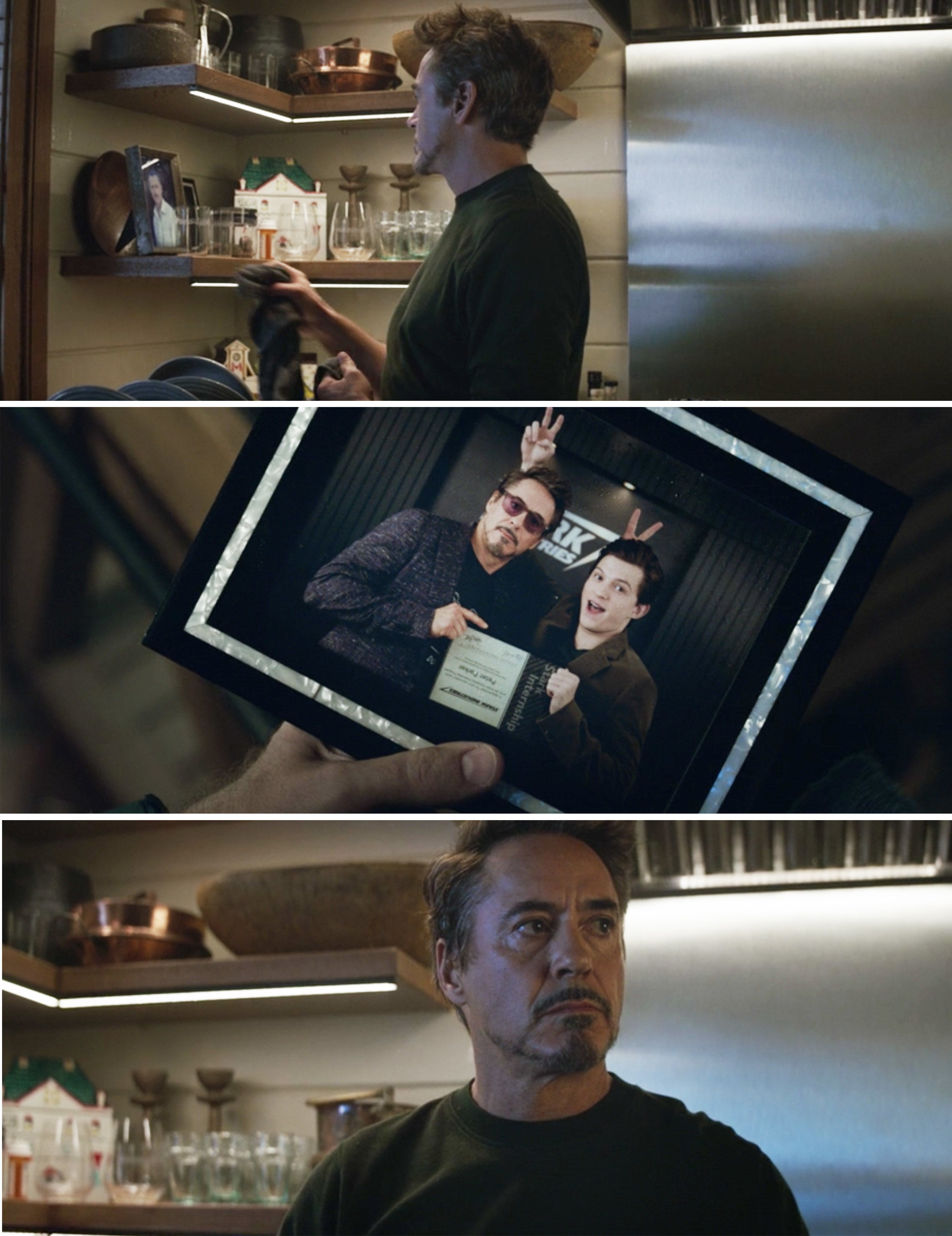 Tony looking at a picture of him and Peter giving each other bunny ears