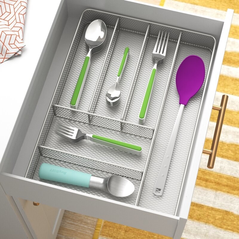 the metal organizer with utensils in a grey drawer