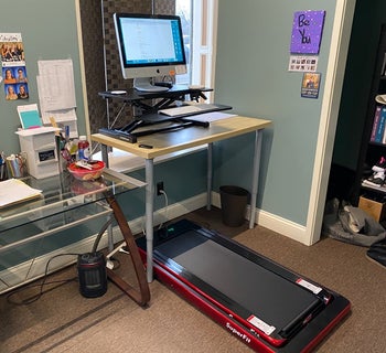 reviewer photo of red under desk treadmill under a desk